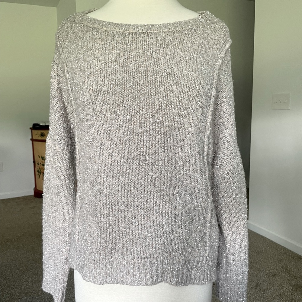 Soft, comfortable blush pink sweater with shiny metallic details.